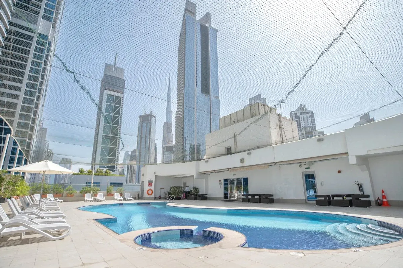 Swimming pool and surrounding skyscrapers Five Star Luxury City Premiere Hotel Apartments - Dubai