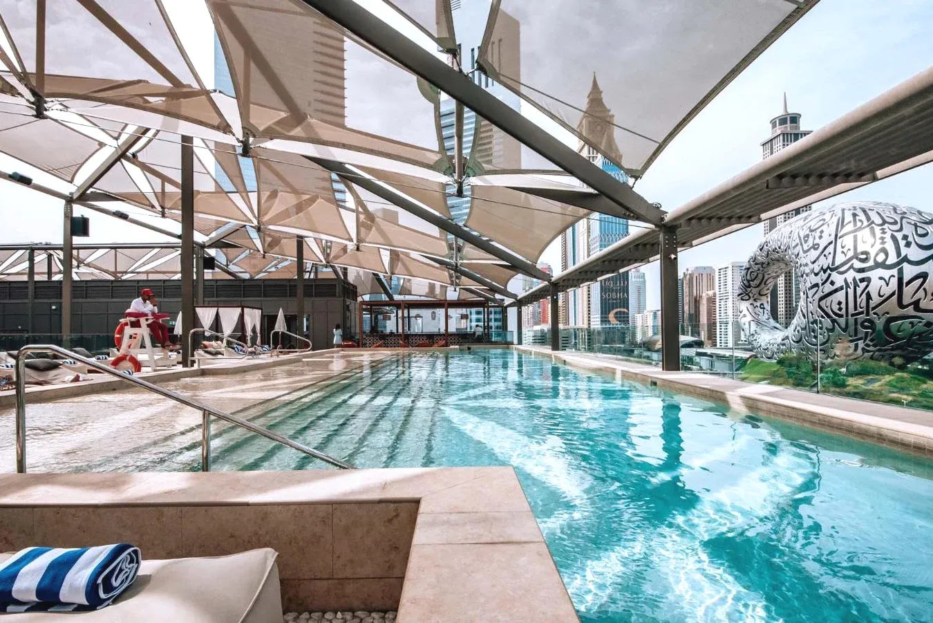 Swimming pool with a building 25hours Hotel Dubai One Central 5-Star Luxury in Trade Center Area