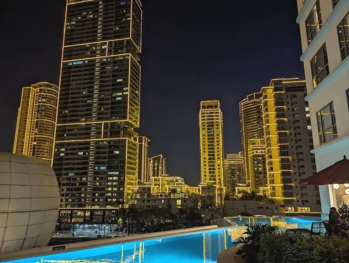 View of a city skyline at night Boutique Style Hotel Acqua Suites Residences Manila by Amira Luxury